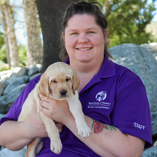 Headshot of Natalie A. Ergler holding a Yellow Lab puppy.