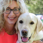 Lorri Bernson hugs her yellow Lab Captain