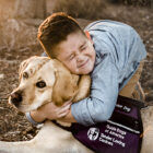 young boy hugging yellow Lab