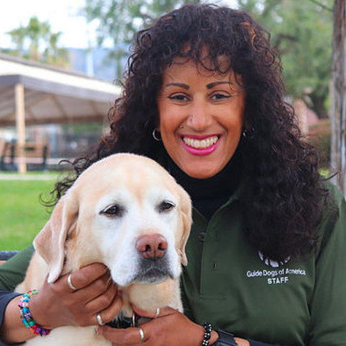 Headshot of Brooke Patterson sitting outside with a Yellow Lab dog.