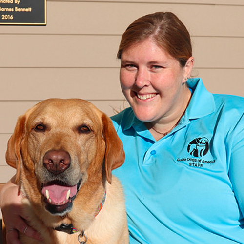 Headshot of Hanna Belyea sitting next to a Yellow Lab dog.