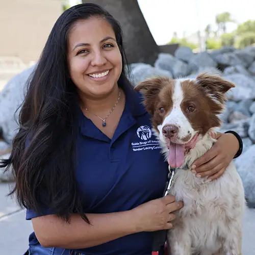 Headshot of Belen Amaya-Morales sitting outside with her pet dog.