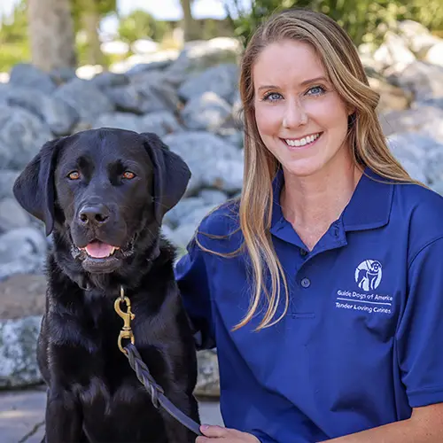 Headshot of Rainie Williams sitting outside with her dog named Scout.