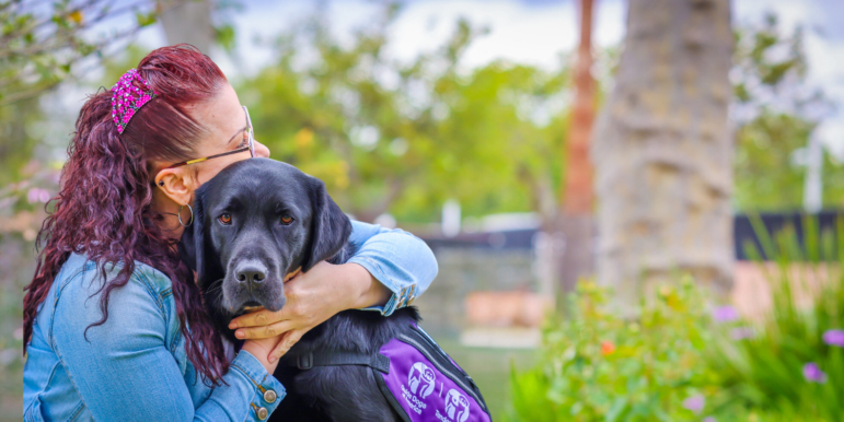 Woman hugging service dog