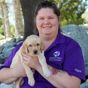 Headshot of Natalie A. Ergler holding a Yellow Lab puppy.