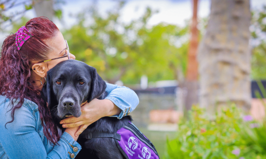 Woman hugging service dog